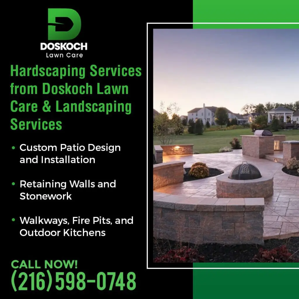 A beautifully designed outdoor living space with a large patio, built-in seating, a fire pit, and an outdoor kitchen area, illuminated at dusk.