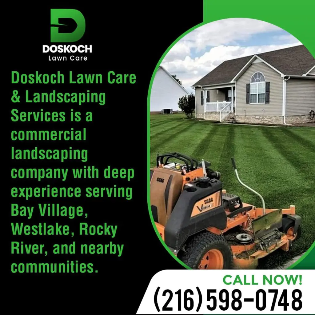 A bright orange commercial lawn mower on a perfectly striped green lawn in front of a residential house