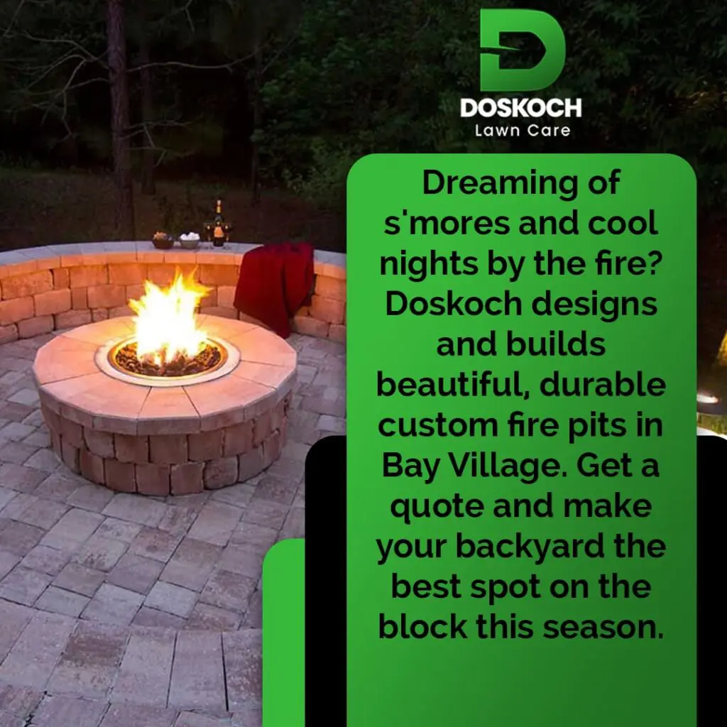 An advertisement for Doskoch Lawn Care showing a beautifully lit custom stone fire pit with a fire burning, set in a paved patio with s'mores ingredients nearby. The text promotes custom fire pits in Bay Village.