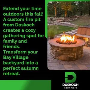 An advertisement for Doskoch Lawn Care featuring a cozy outdoor fire pit with a fire burning, surrounded by stone paving and landscaping, with trees in the background. The text encourages extending outdoor time this fall with a custom fire pit in Bay Village.