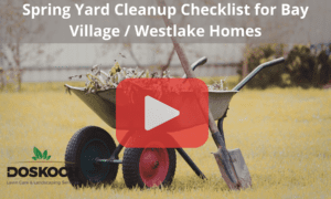Wheelbarrow with shovel and sticks. Red play buttom overlay with words: Spring Yard Cleanup Checklist for Bay Village / Westlake Homes