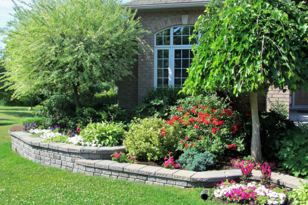 Small stone retaining wall with landscaping designs.