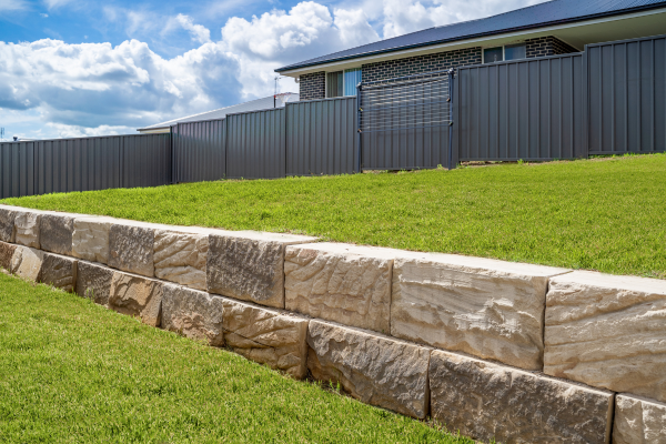 Stone retaining wall on yard.