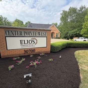Commercial Mulching Fresh black mulch and seasonal flowers around a commercial sign at Center Pointe West